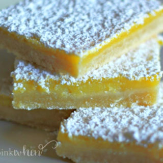 Lemon Bars stacked and topped with powdered sugar.