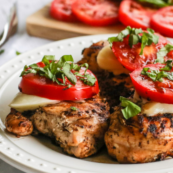 Caprese Chicken served on a white dish.