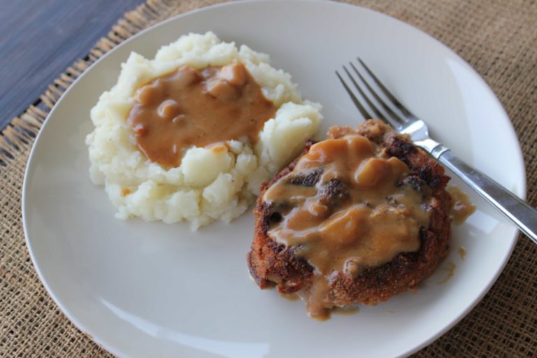Baked pork chops and mashed potatoes on white plate