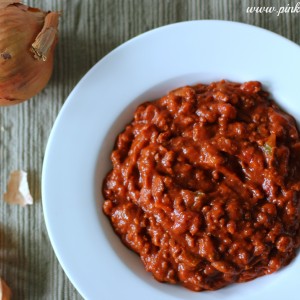 chili in a white bowl with onion