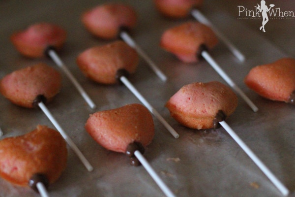 Dip your sticks in chocolate and place through the heart and allow to cool