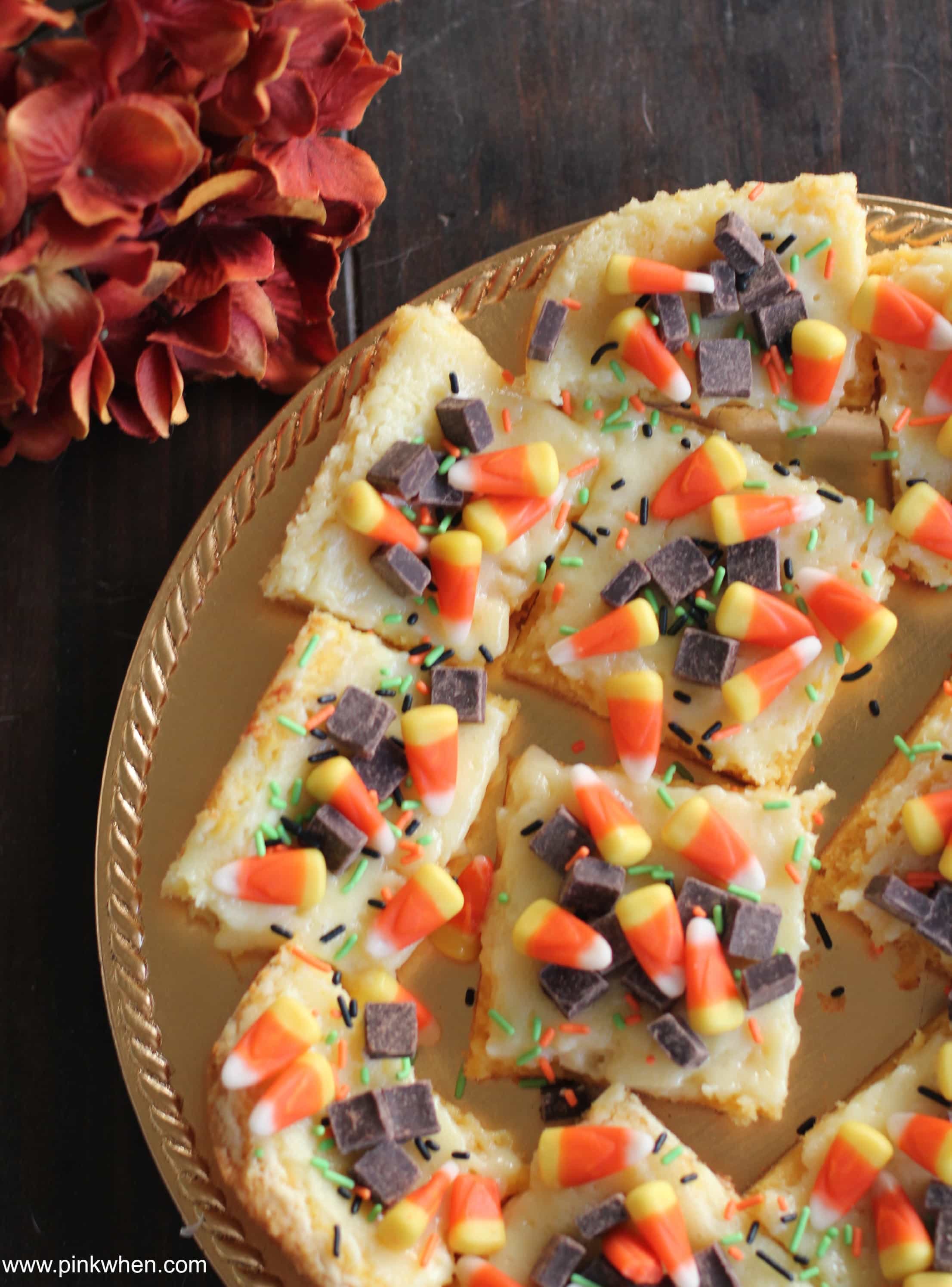 Fall Inspired Ooey Gooey Cake Mix Cheesecake Bars via PinkWhen.com 2