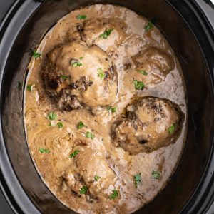 Slow Cooker Salisbury Steak in the liner of a Crock pot.