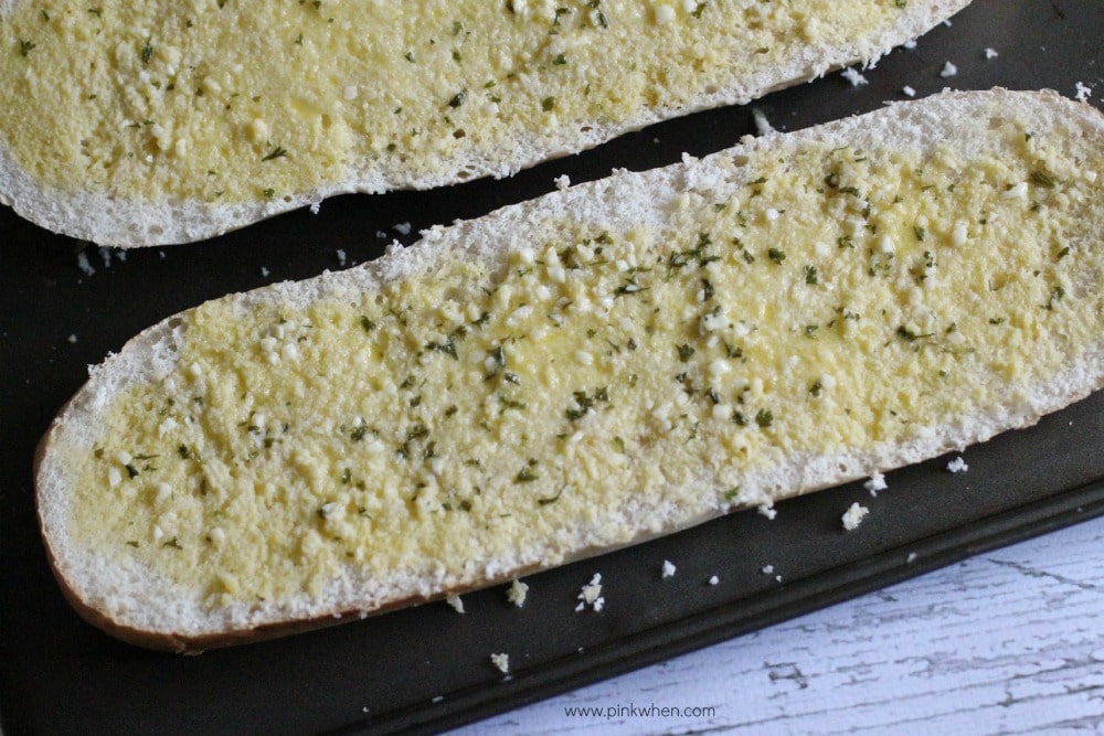 bread basted with butter and oil on a cookie sheet