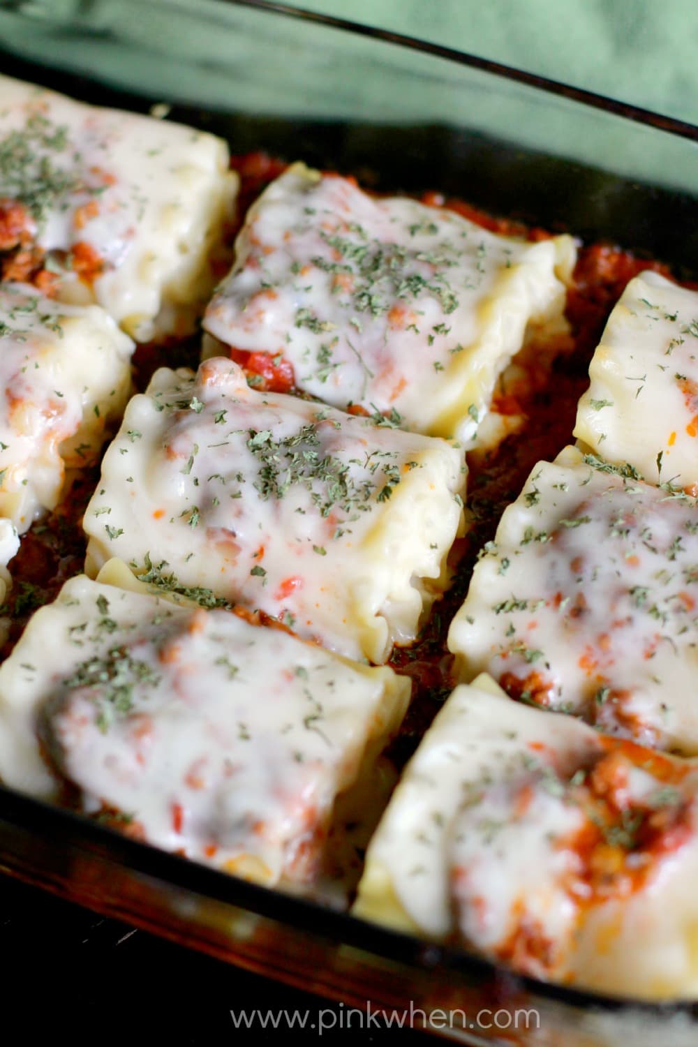 Fully cooked lasagna rolls in a baking dish. 