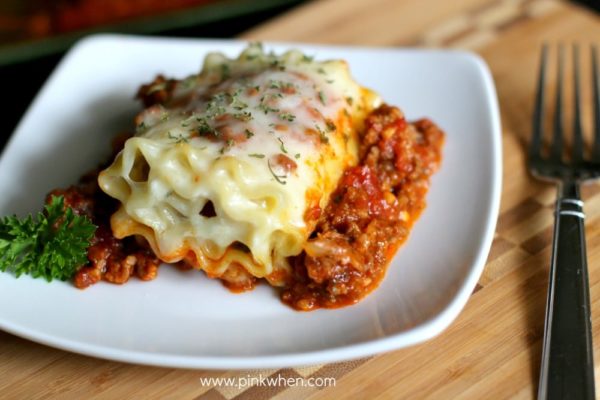 Lasagna roll on a white plate. 