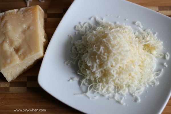Shredded cheese on a white plate. 