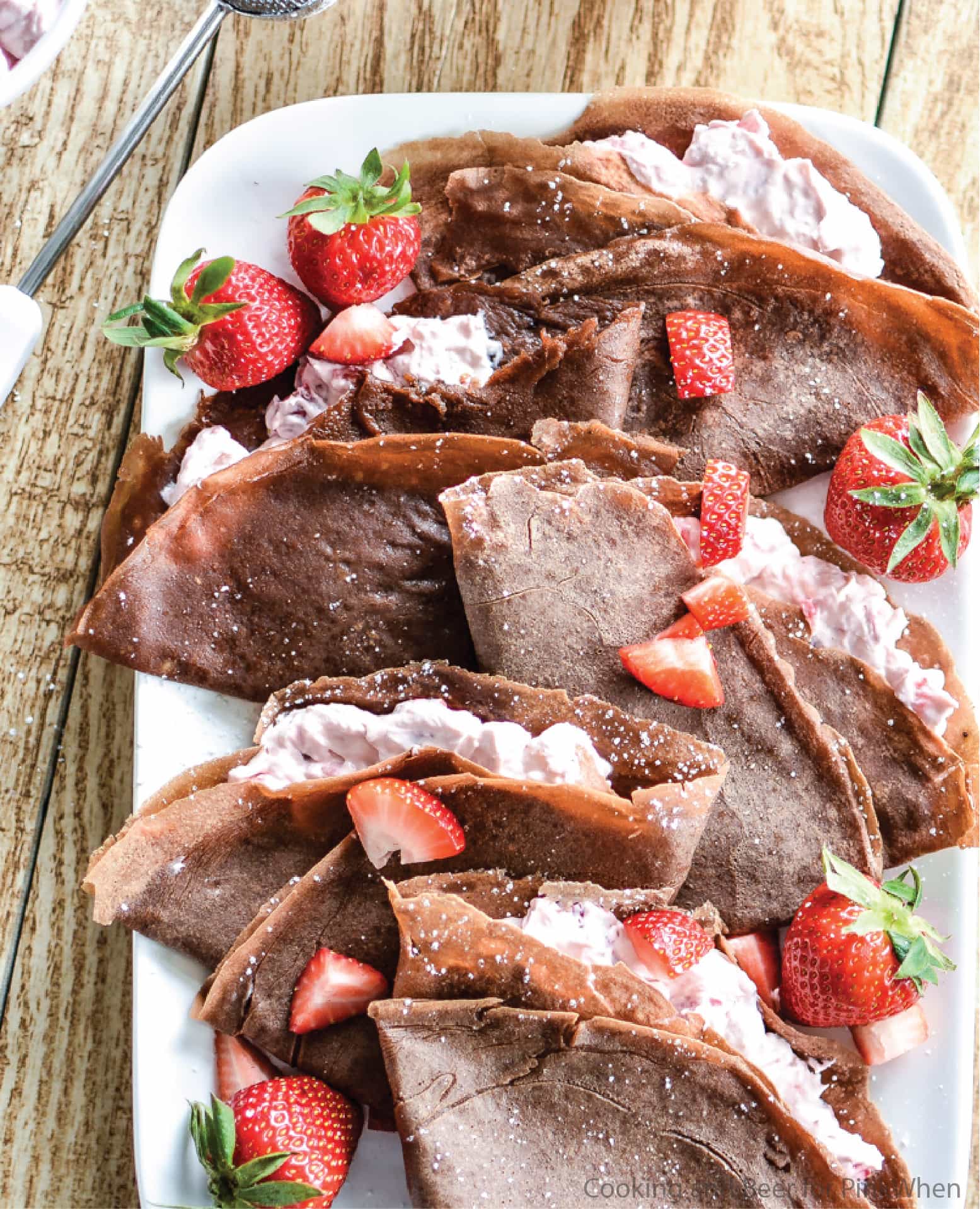 Strawberry Cheesecake Chocolate Crepes served on a white dish. 