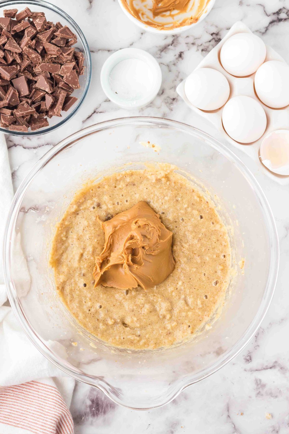 Creamy peanut butter being mixed into batter. 