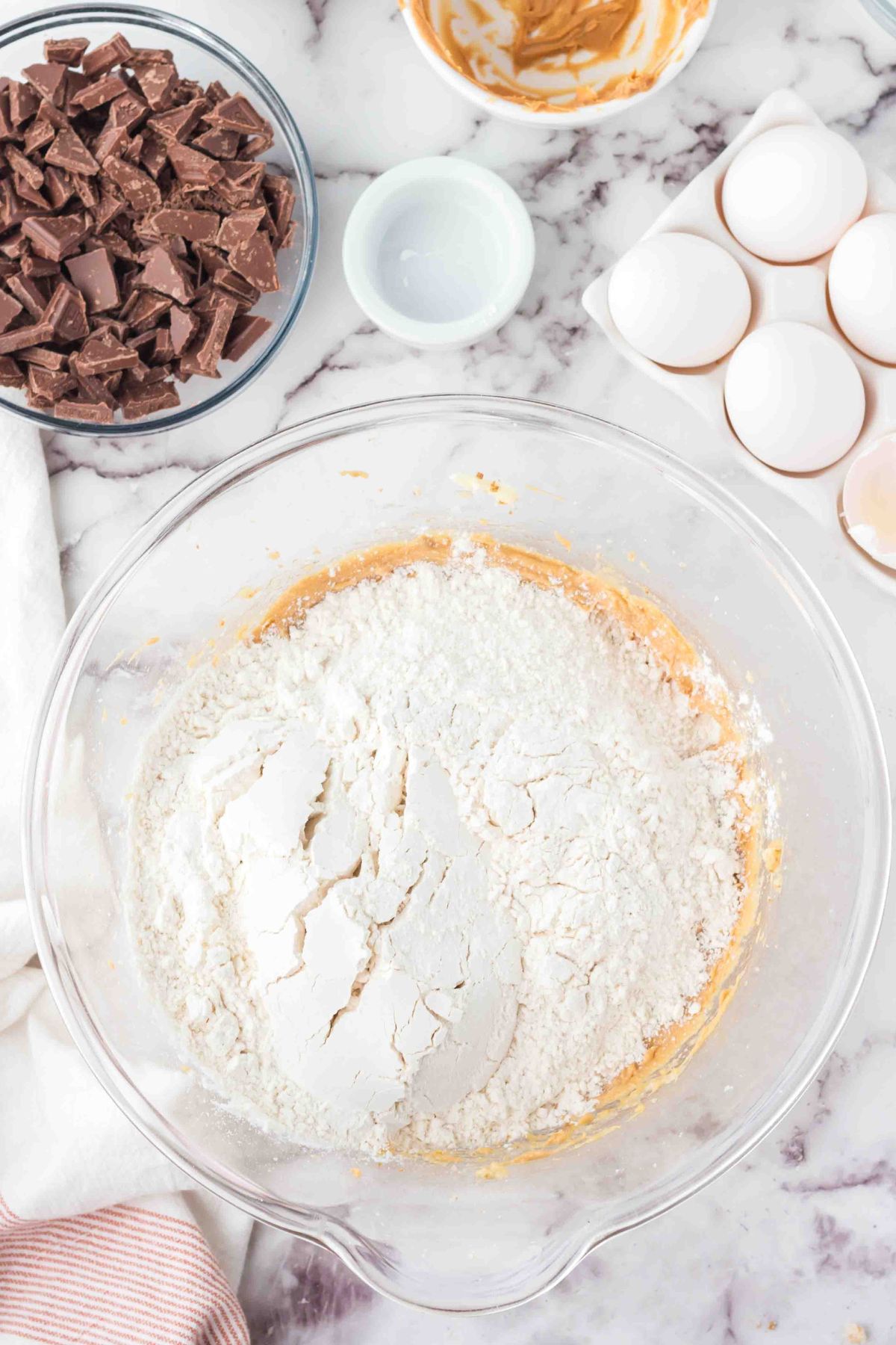 Flour and other dry ingredients being mixed into the batter.