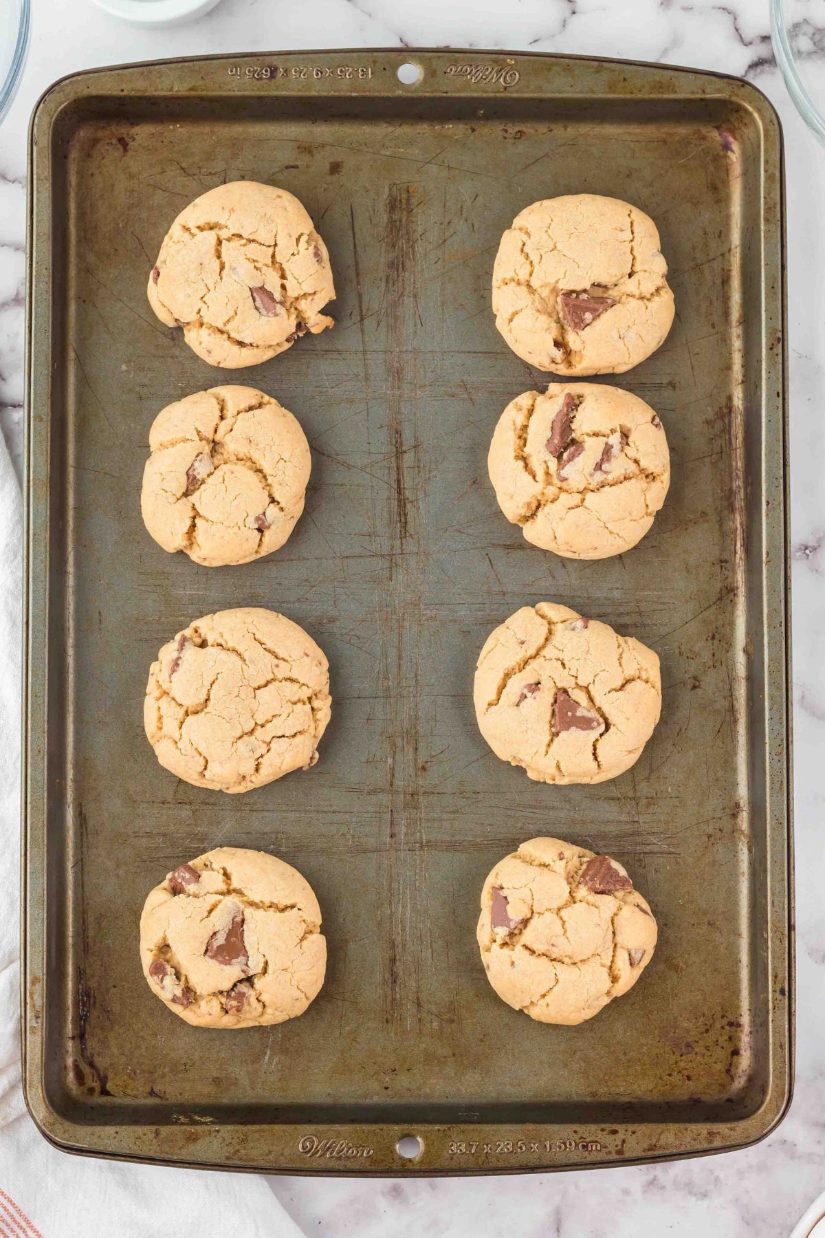 Golden baked cookies on a metal baking sheet