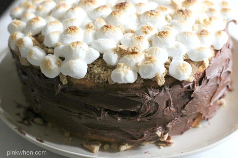 Frosting the sides of the S'mores cake. 