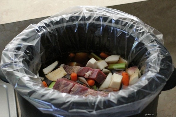Vegetables and Meat in a liner for a Slow Cooker Pot Roast. 