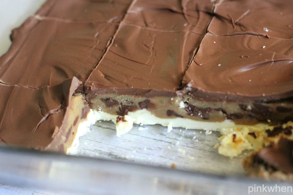 cooled cookie dough bars cut into bites still in glass baking dish.