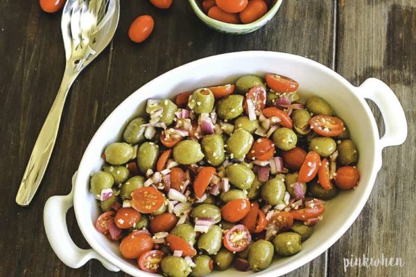 Tomato Salad with Olives topped with parmesan cheese.