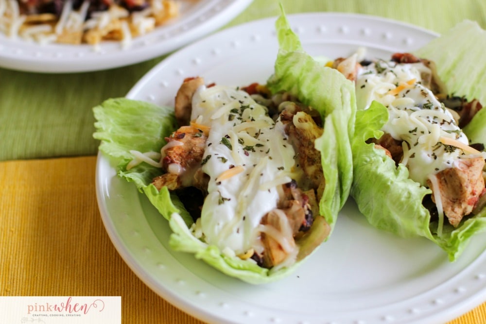 Chicken Tacos on a bed of lettuce on white plate