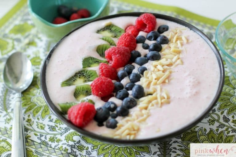 A Berry-licious smoothie bowl recipe made with strawberries, almonds, greek yogurt, organic milk, kiwi, blueberries, and raspberries. All with the daily recommended protein for breakfast of 25-30 grams! 