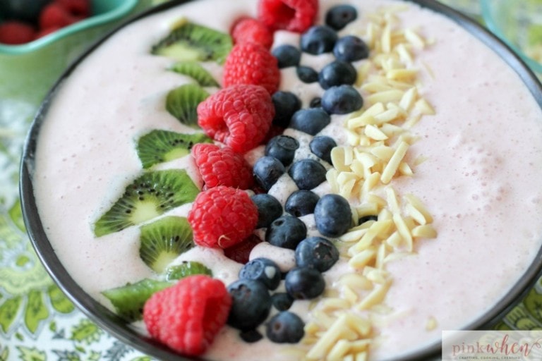 A Berry-licious smoothie bowl recipe made with strawberries, almonds, greek yogurt, organic milk, kiwi, blueberries, and raspberries. All with the daily recommended protein for breakfast of 25-30 grams!
