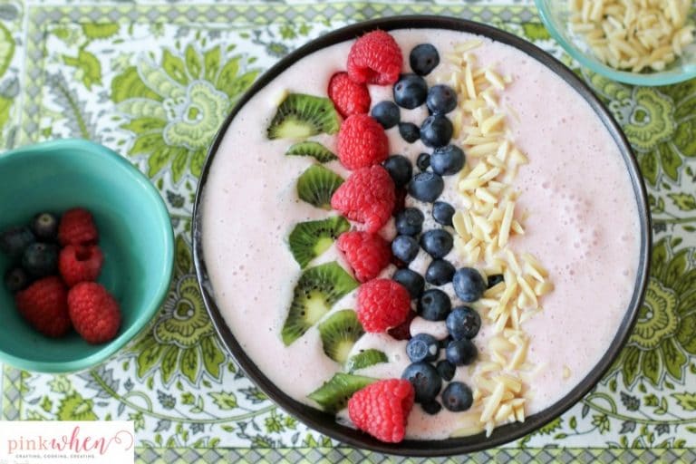 A Berry-licious smoothie bowl recipe made with strawberries, almonds, greek yogurt, organic milk, kiwi, blueberries, and raspberries. All with the daily recommended protein for breakfast of 25-30 grams! 