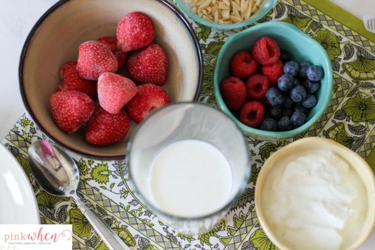 A Berry-licious smoothie bowl recipe made with strawberries, almonds, greek yogurt, organic milk, kiwi, blueberries, and raspberries. All with the daily recommended protein for breakfast of 25-30 grams! 