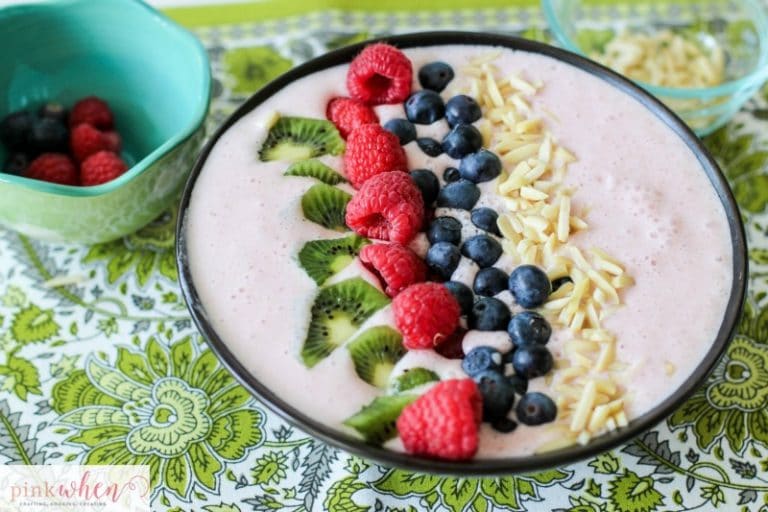 A Berry-licious smoothie bowl recipe made with strawberries, almonds, greek yogurt, organic milk, kiwi, blueberries, and raspberries. All with the daily recommended protein for breakfast of 25-30 grams! 