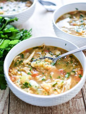 red lentil soup on wood table with spoon