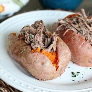 Shredded Roast Beef Stuffed Sweet Potatoes on white plate
