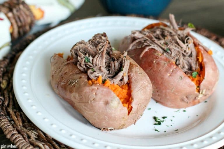 Shredded Roast Beef Stuffed Sweet Potatoes on white plate