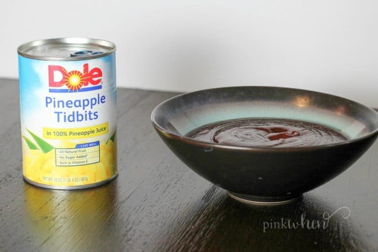 Pineapple and barbecue sauce on a dark table. 