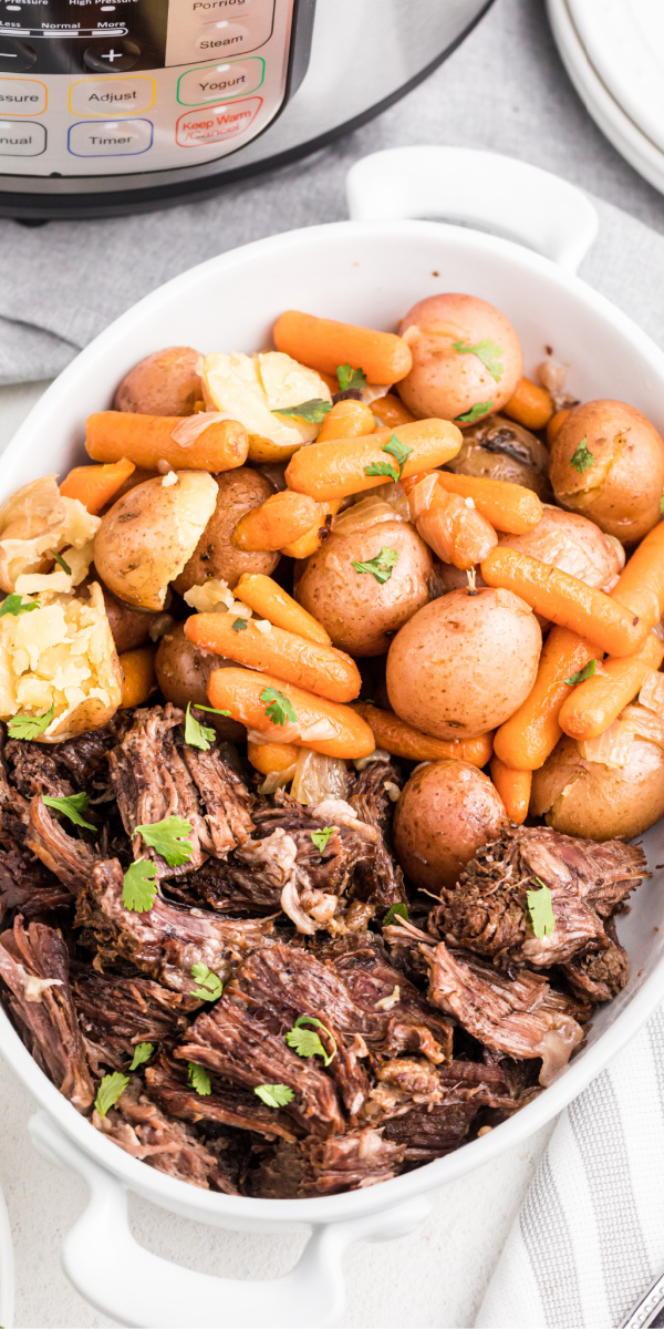 Family-Approved! Take the guesswork out of dinner with this quick and easy Pot Roast made in the pressure cooker. Made with roast, carrots, potatoes, and more. It's the perfect hearty meal the whole family will love.