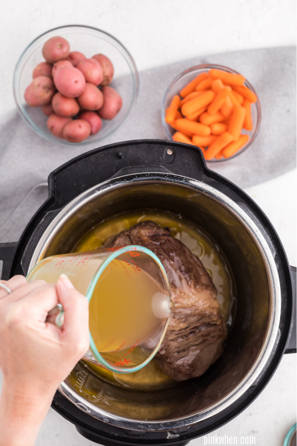Pouring broth into the pressure cooker. 