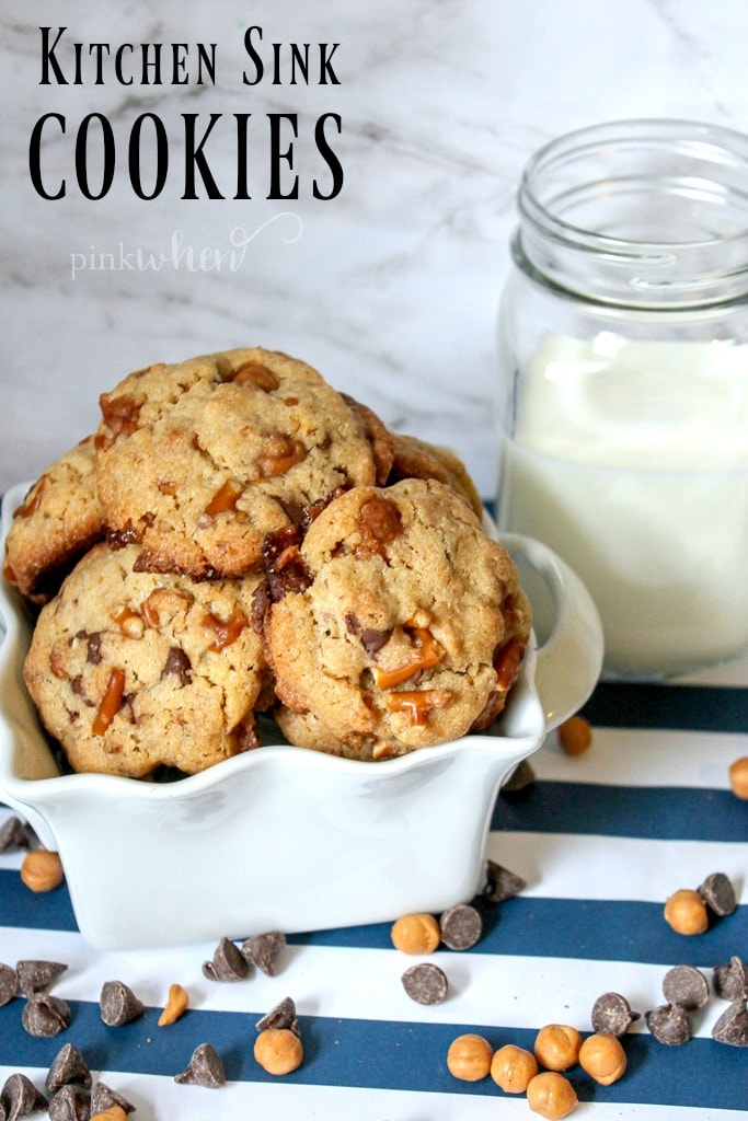 Kitchen sink cookies in a white dish with a glass of milk. 