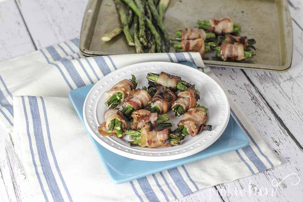 Quick and easy bacon wrapped asparagus. The perfect addition to any menu for the grill. #bacon #asparagus #sidedish #grilledrecipe