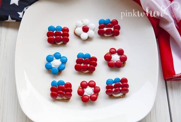 pretzel with chocolate candies on a white plate.