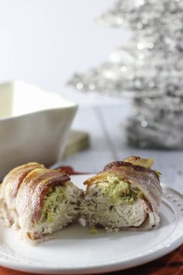 bacon wrapped stuffed chicken on white plate