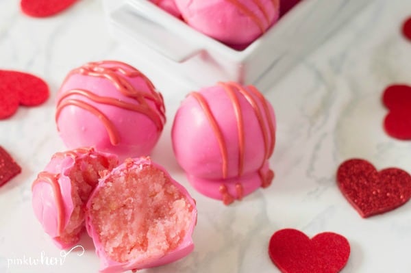 Easy cake balls recipe covered in melting chocolates in white tray. 