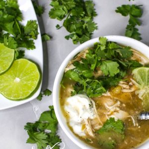 Crock Pot White Chicken Chili in a white bowl with toppings.