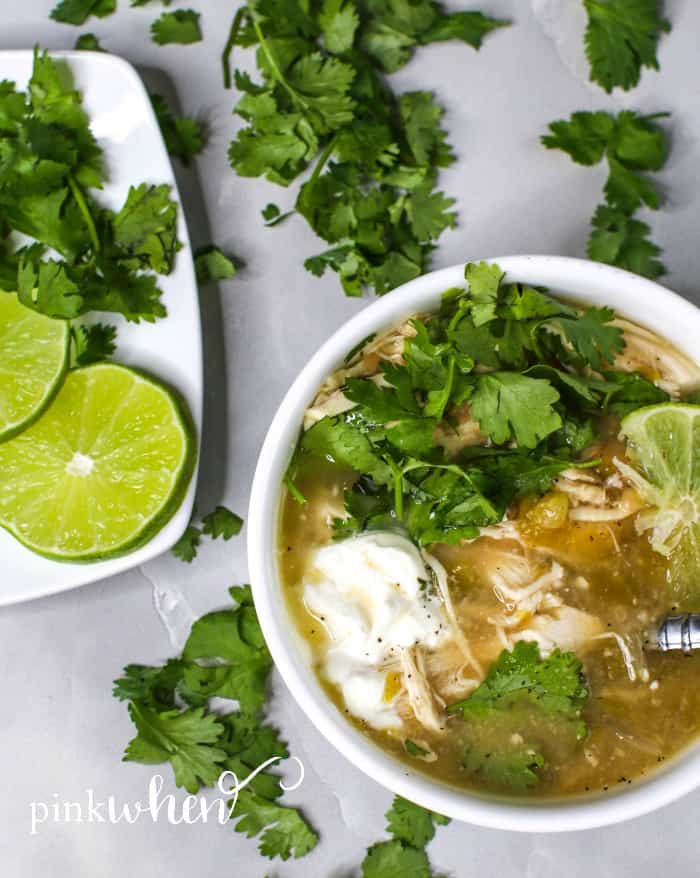 Crock Pot White Chicken Chili in a white bowl with toppings.