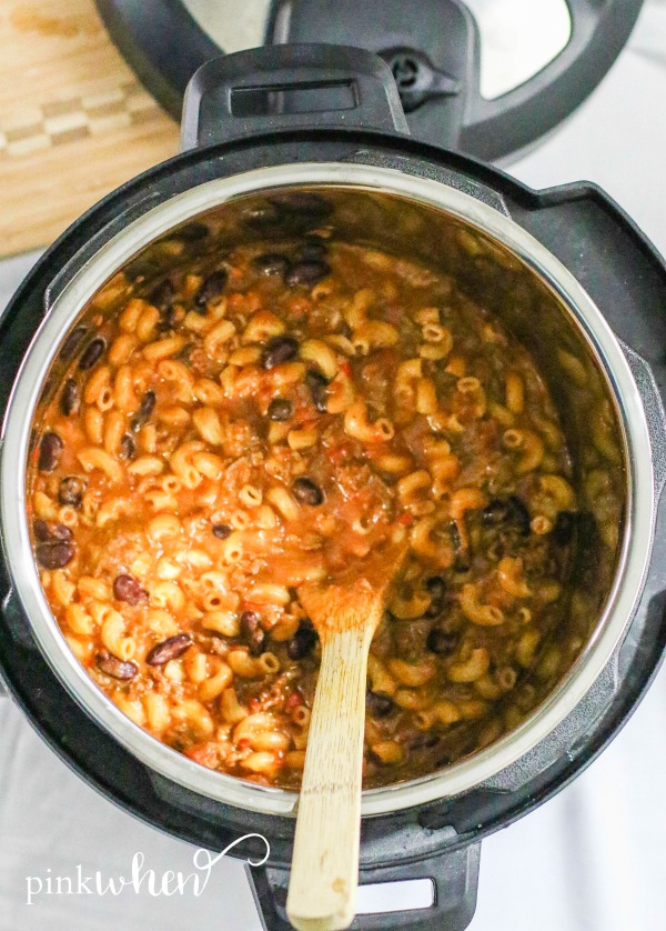 Chili Mac in the Instant Pot with wooden spoon. 