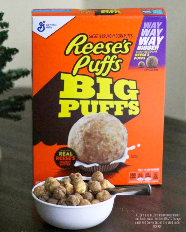 Reese's Puffs Big Puffs cereal in a bowl with box of cereal behind it. 