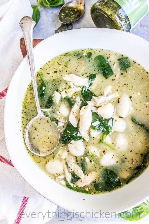 chicken gnocchi soup in a white bowl with spoon. 