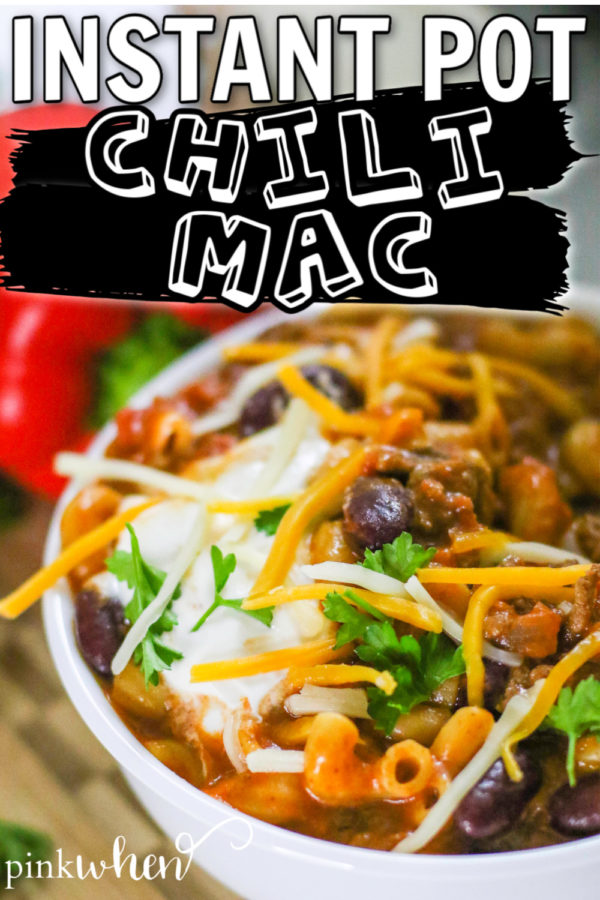 Instant Pot Chili Mac in a white bowl with sour cream and cheese toppings. 