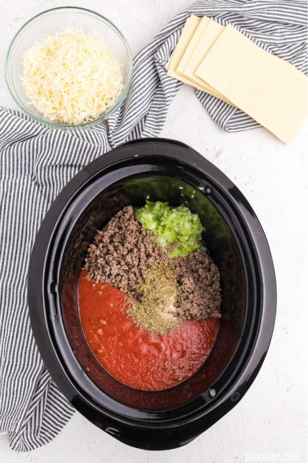 Ingredients added to a slow cooker.