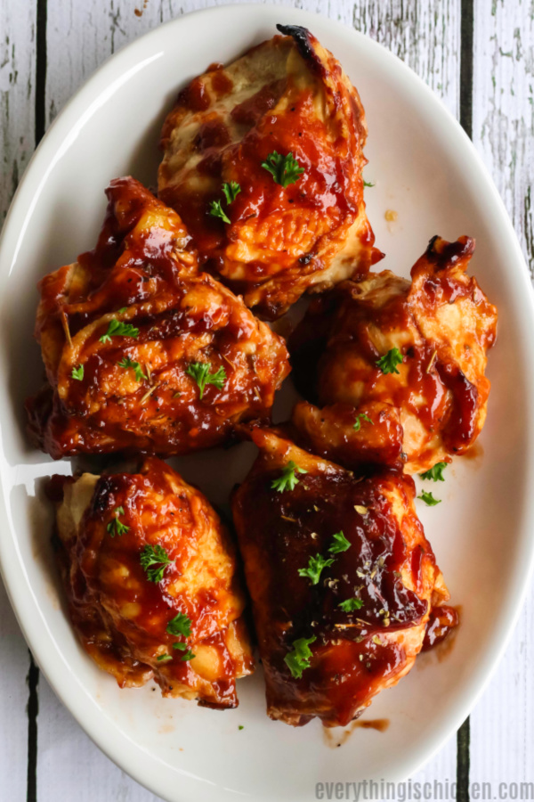 oven baked bbq chicken in a white plate ready to serve. 