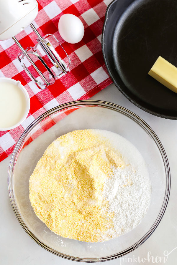 Ingredients in a bowl ready to combine to make easy cornbread. 