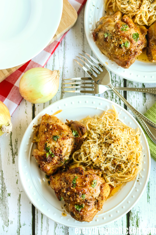 Blackened chicken in garlic butter sauce on a white plate ready to serve.