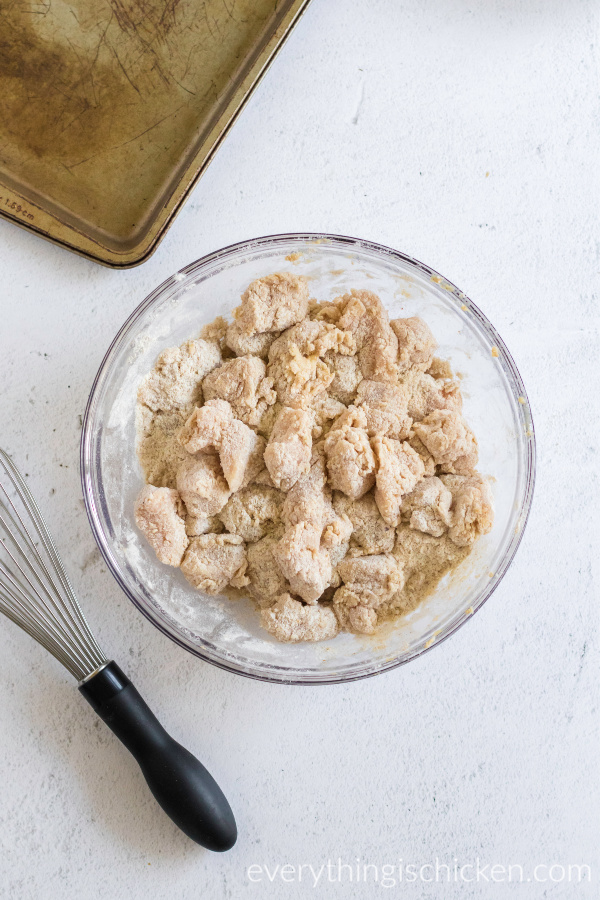 chicken nuggets dredged in flour mixture ready to fry.