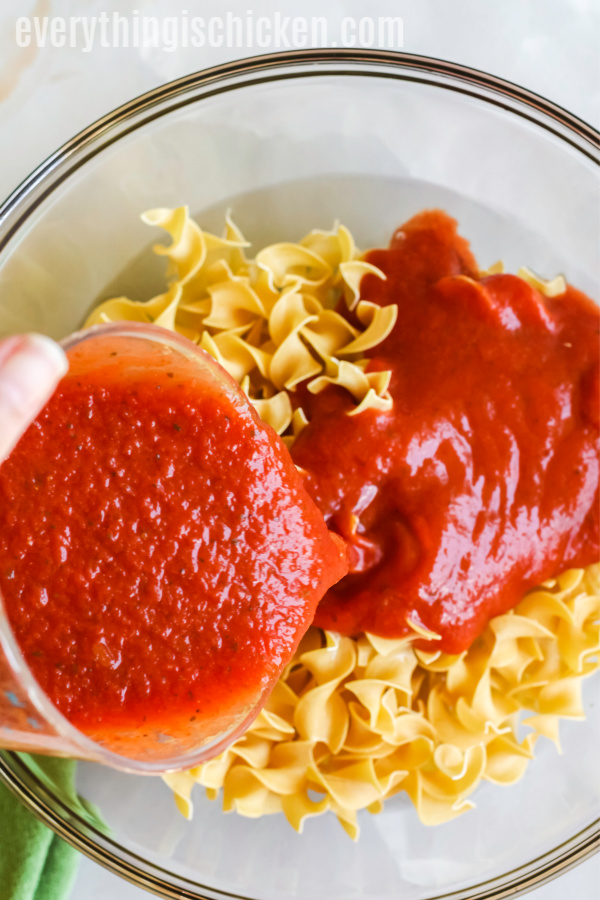 Adding sauce to noodles for casserole. 