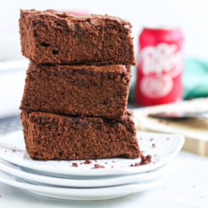 Dr. Pepper Brownies stacked on a plate.