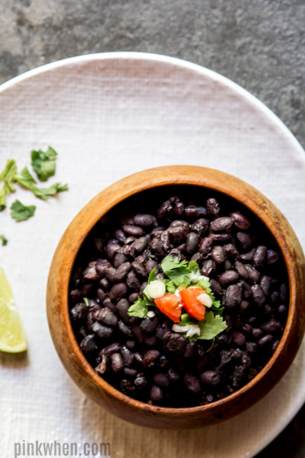 Instant Pot Black Beans in a bowl and on a plate ready to serve.